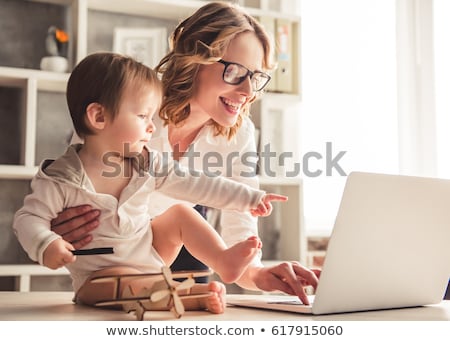 Stockfoto: Working Mother With Baby Boy And Laptop At Home