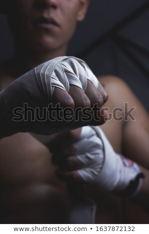 Stockfoto: Fighter Putting Straps On His Hands