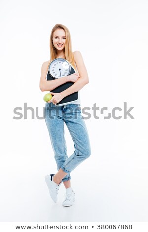 Stock foto: Beautiful Joyful Woman Posing With Scales And Green Apple