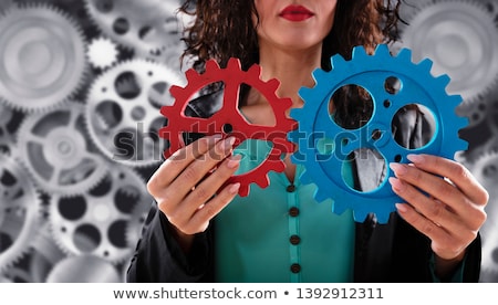 Zdjęcia stock: Businesswoman Tries To Connect Gears Pieces Concept Of Teamwork Partnership And Integration
