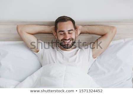 [[stock_photo]]: Man Lying On Bed Awake