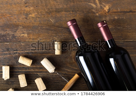 Foto stock: Dusty Old Bottle And Glass Of White Wine On A Wooden Table