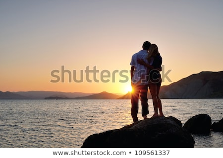 Stock photo: Couple Embrace On A Stone In Sea