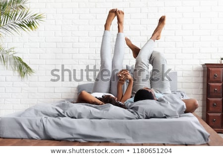 [[stock_photo]]: Young Adult Couple Lying On Bed