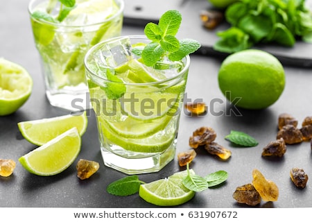 Stok fotoğraf: Summer Mint Lime Refreshing Cocktail Mojito With Rum And Ice In Glass On Black Background