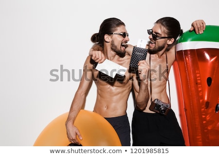 Stockfoto: Portrait Of A Two Laughing Muscular Shirtless Twin Brothers