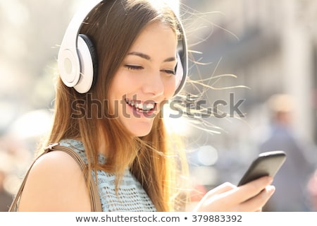 Stock foto: Close Up Of Woman Listening To Music In Earphones