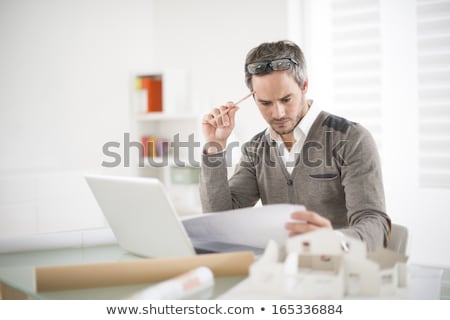 Stockfoto: Portrait Of An Engineer Working On A Project In His Office