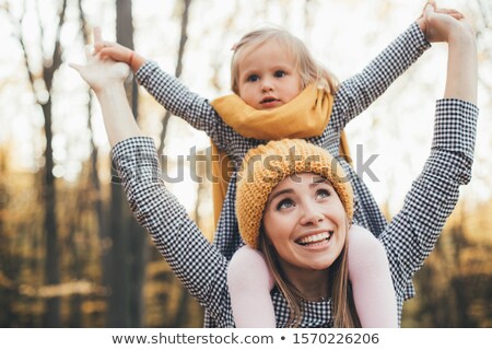 Zdjęcia stock: Image Of Two Positive Women Wearing Hats And Scarfs Holding Take