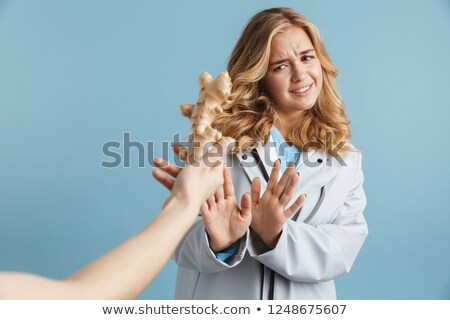 Foto d'archivio: Image Of Dissatisfied Woman 20s Wearing Raincoat Doing Stop Gest