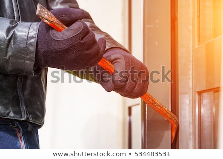 Foto d'archivio: Burglar Trying To Open Window With Crowbar