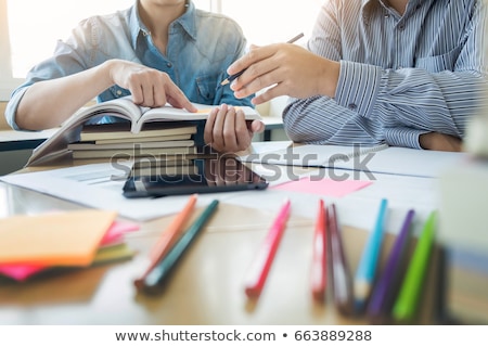 Foto stock: Tutor Books With Friends Young Students Campus Or Classmates He