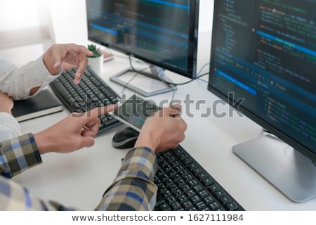 Foto d'archivio: Pensive Programmer Working On On Desktop Pc Programming Code Tec