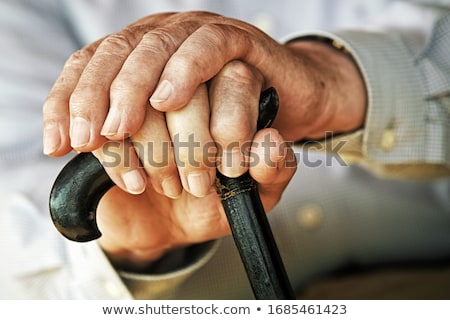 Foto stock: Elderly Hands Resting On Walking Stick