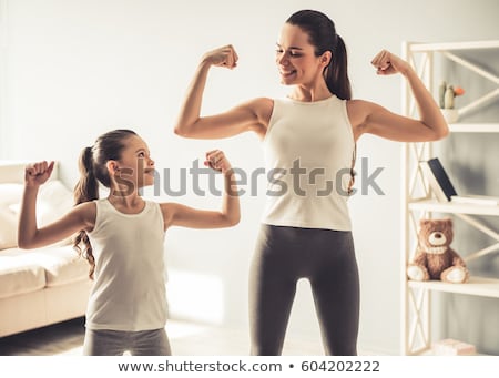 Stock photo: Happy Charming Woman Working Out At Gym