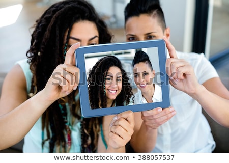 Foto stock: Close Up Of Lesbian Couple With Tablet Pc At Home