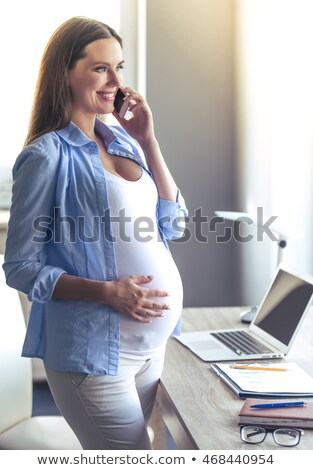 Foto stock: Pregnant Businesswoman Talking On Mobile Phone