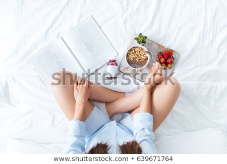 Stok fotoğraf: Young Woman Eating Breakfast In Bed