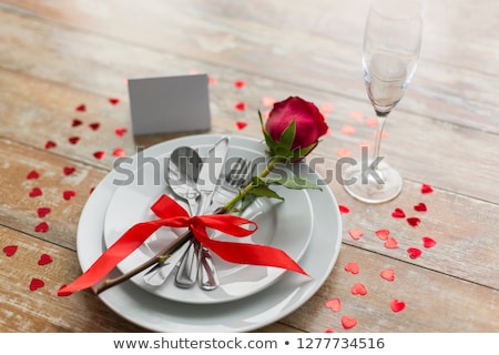 Foto d'archivio: Close Up Of Red Rose Flower On Set Of Dishes