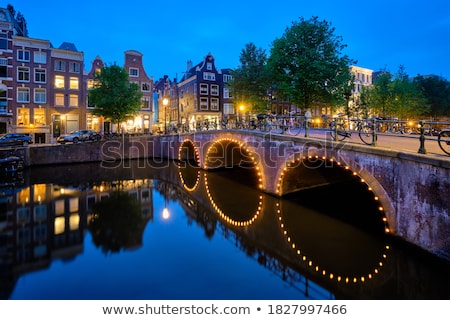 [[stock_photo]]: Amterdam Canal Bridge And Medieval Houses In The Evening