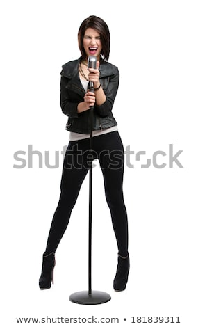 Stock photo: Studio Shot Of A Young Woman Singing Into A Microphone