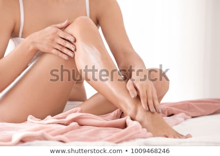 Foto stock: Woman Applying Moisturizer Cream On The Legs