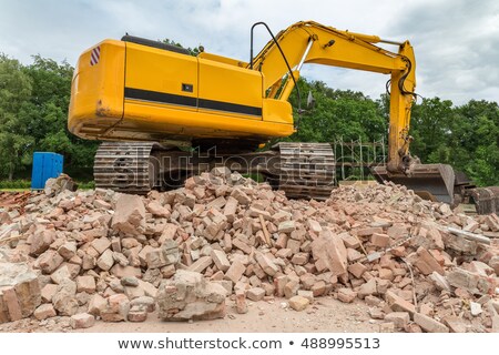 Сток-фото: Yellow Belt Excavator On Heap Of Bricks