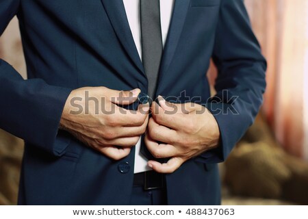 Stock photo: Happy Young Business Man Buttoning His Suit