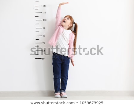 [[stock_photo]]: A Girl Measuring The Height