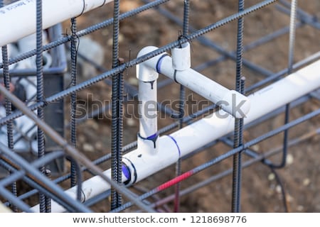 [[stock_photo]]: Newly Installed Pvc Plumbing Pipes And Steel Rebar Configuration