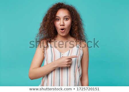 Сток-фото: Photo Of Young Woman 20s With Curly Hair Pointing Finger At Mobi