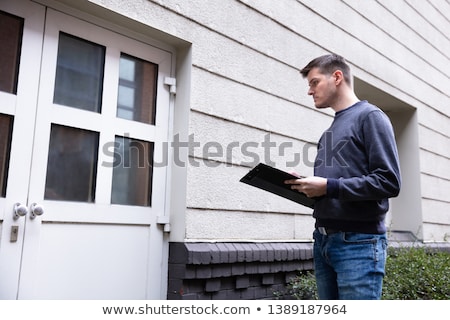 Сток-фото: Service Man Standing In Front Of Closed Door