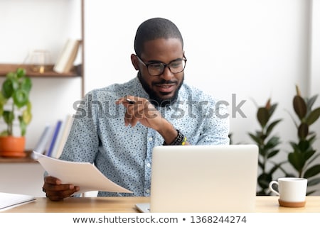 Stock photo: Professional Businessman Working At Workplace With Report Doing
