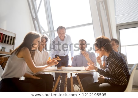 Foto stock: Indian Delivery Man With Takeaway Pizza At Office