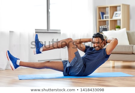 Foto stock: Indian Man Making Abdominal Exercises At Home
