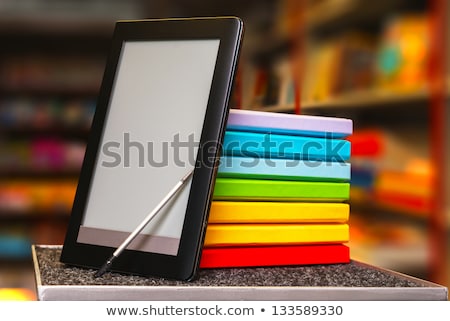 Stock photo: Row Of Colorful Books With Electronic Book Reader