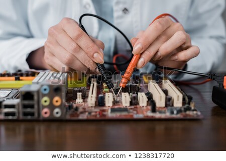 Foto stock: Woman Repairing An Electronic Component