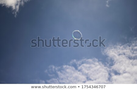 Stok fotoğraf: Blue Bubbles In Clear Water Against Orange