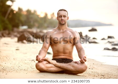 Zdjęcia stock: Man Practices Yoga On Coast - Meditation