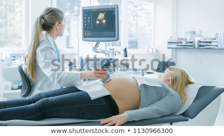 Foto stock: Pregnant Woman Displaying A Prenatal Ultrasound