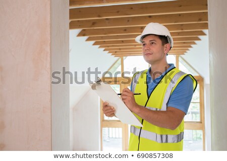 Stok fotoğraf: Building Inspector Looking At New Property