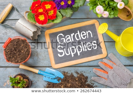 Foto stock: Blackboard On A Plant Table With Garden Tools - Garden Time