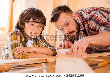 Stock fotó: Father And Son With Chisel Working At Workshop
