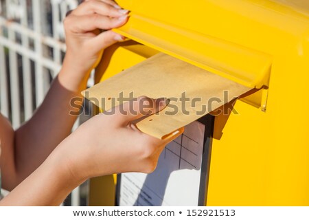 [[stock_photo]]: Persons Hand Inserting Envelopes In Mailbox