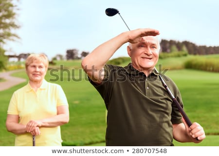 Stock fotó: Couple Standing Near Golf Cart