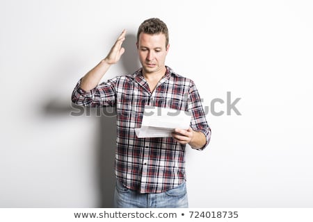 ストックフォト: Shocked Man Holding Some Documents Isolated On Gray Background
