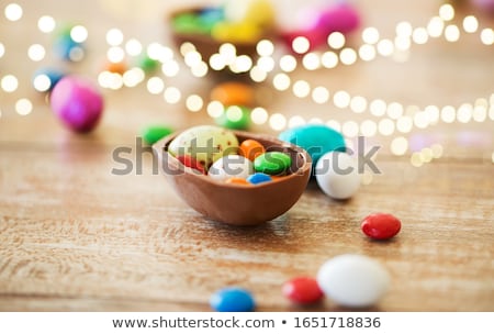 Foto stock: Chocolate Easter Eggs And Candy Drops On Table