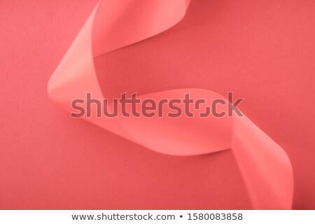 [[stock_photo]]: Abstract Curly Silk Ribbon On Coral Background Exclusive Luxury