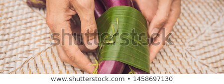 Foto stock: Banner Long Format Eco Friendly Product Packaging Concept Eggplant Wrapped In A Banana Leaf As An