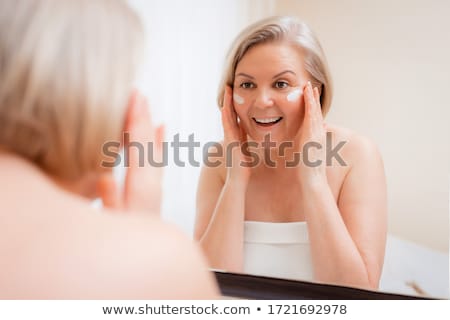 Сток-фото: Elderly Woman Looks In The Mirror